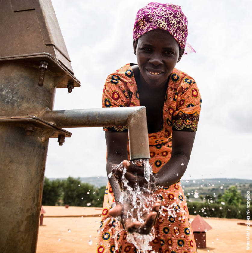 Photo of a woman in Rwanda using clean water