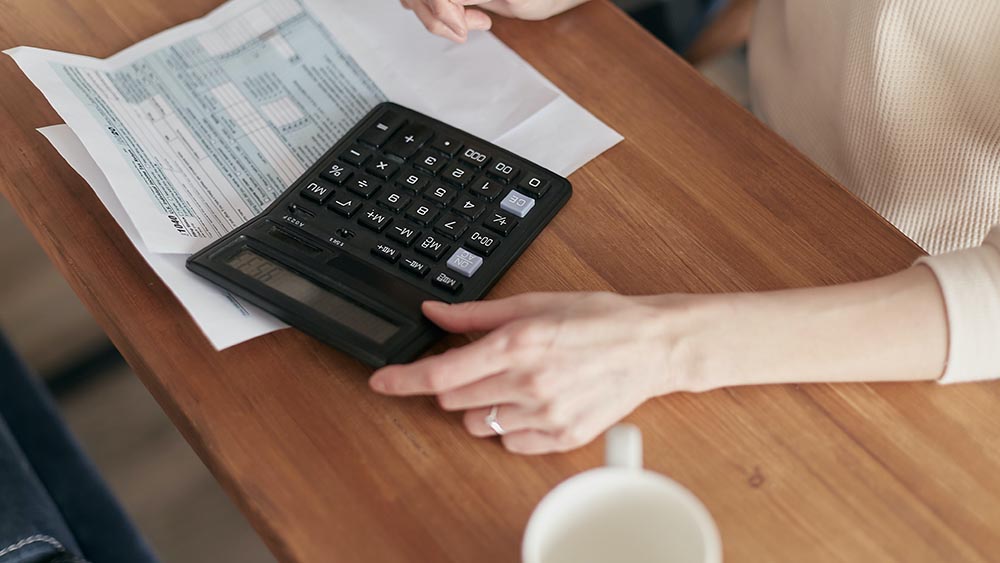 picture of person looking at their bill with a calculator